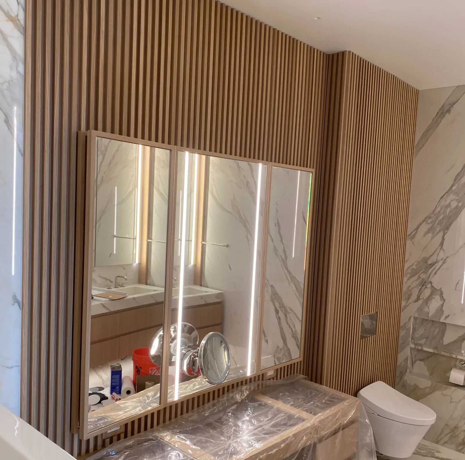 Floor-to-ceiling custom wood paneling and joinery detail by Cano's Wood Interiors