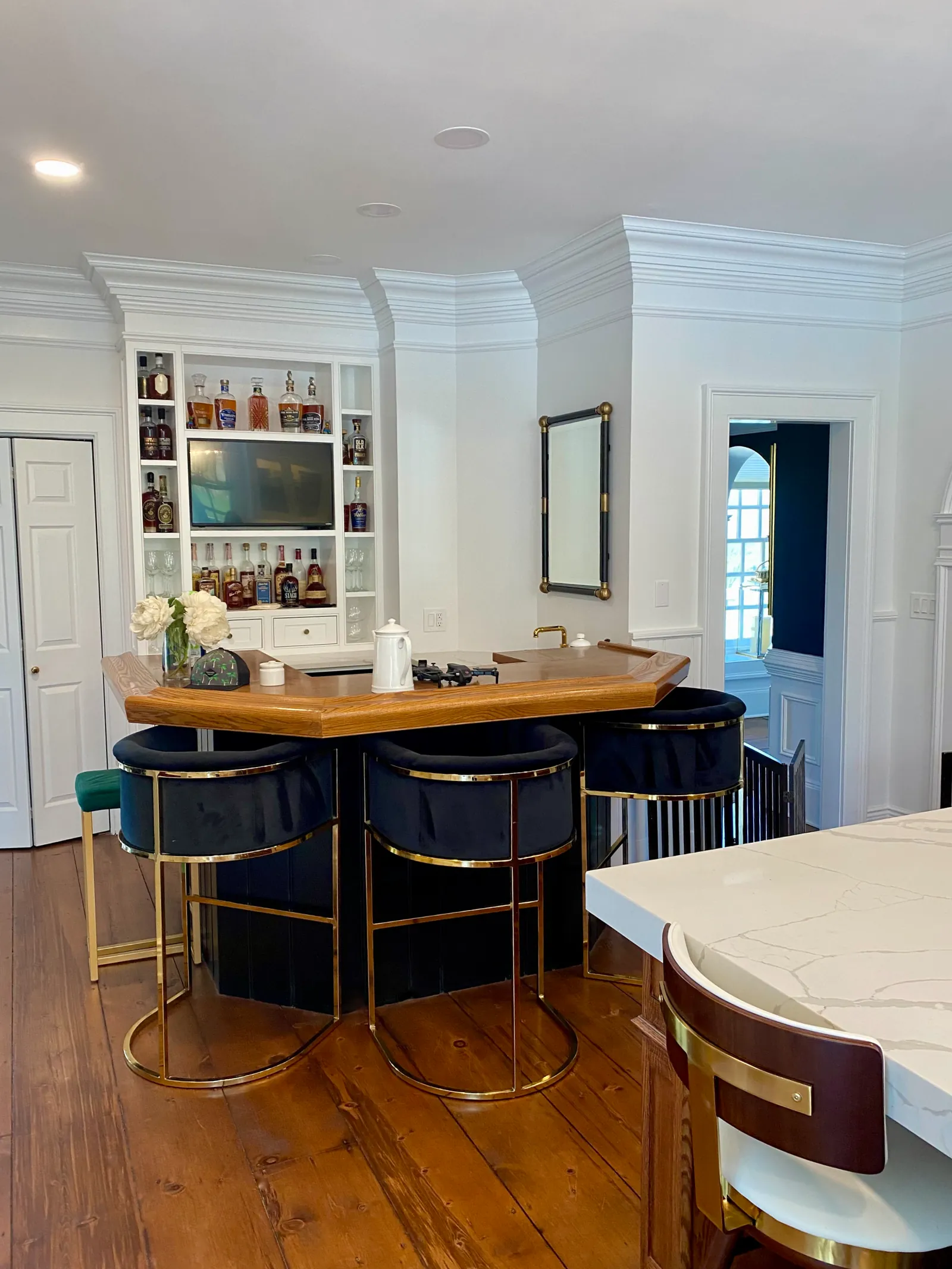 The finished custom kitchen — full-height cabinetry and island, built and installed by Cano's Wood Interiors